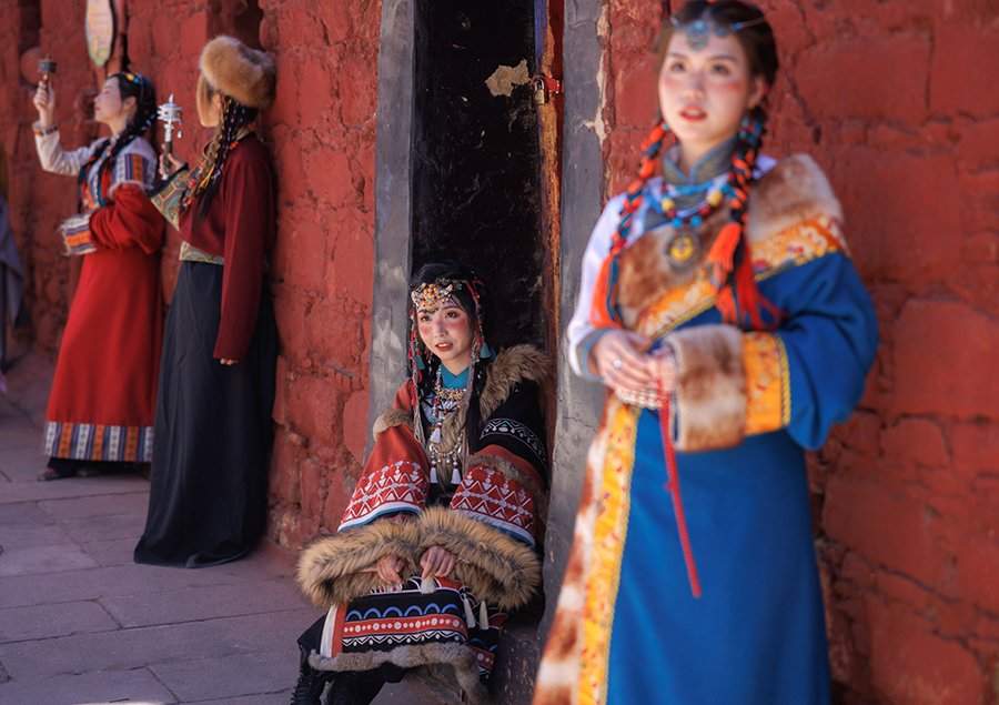 بازدیدکنندگان با لباس های سنتی در یکی از معابد در لهاسا